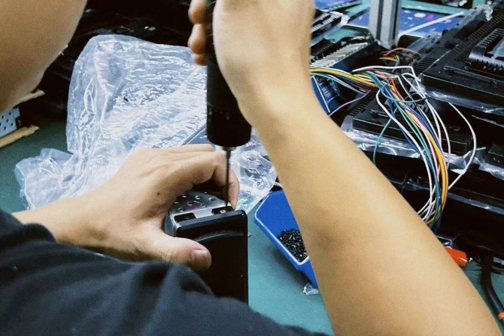 Technician bench-testing a vehicle-specific digital cluster during warranty review