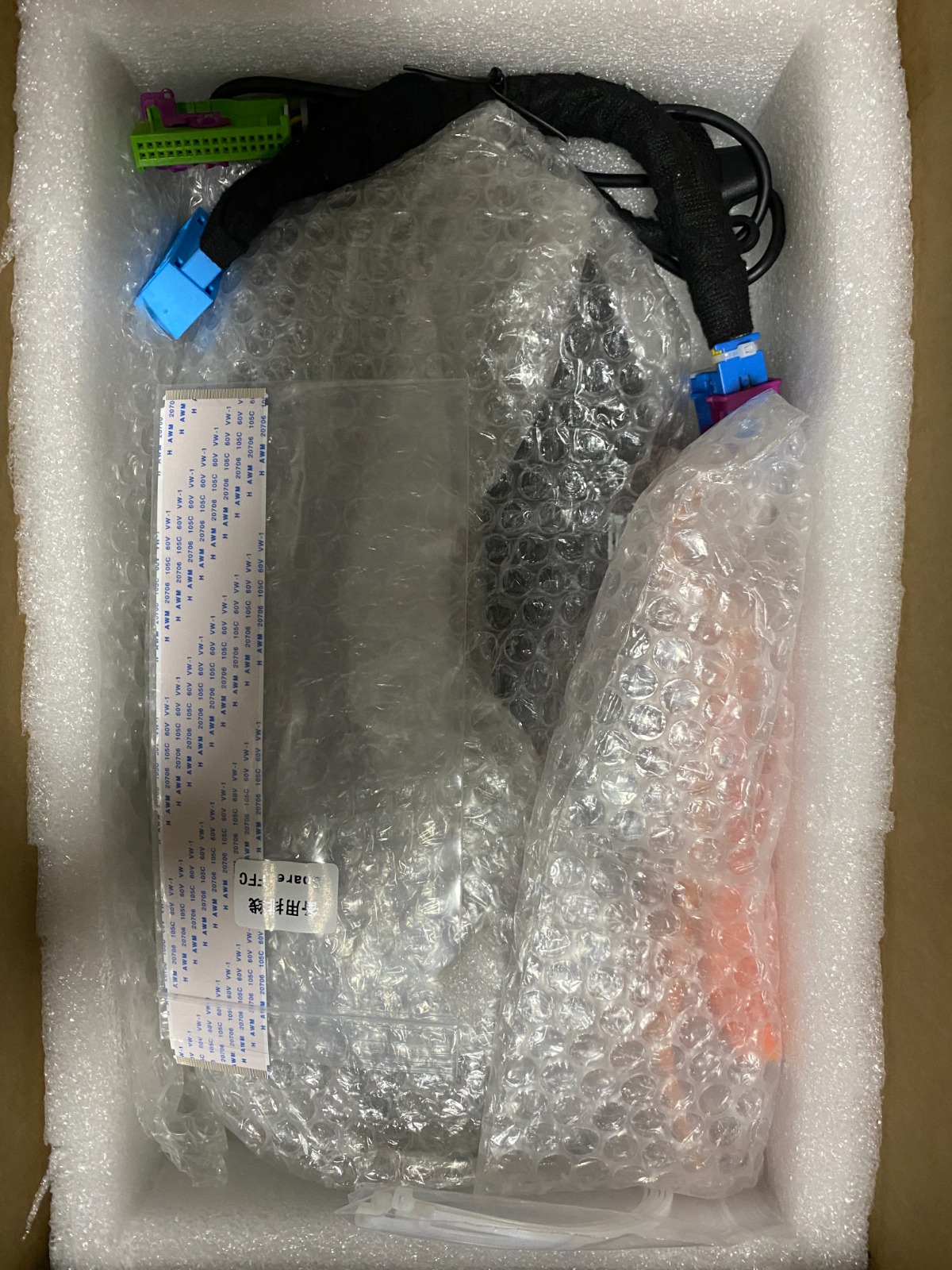 Exploded view of packaging: outer carton, multi-layer foam, device, and accessories separated