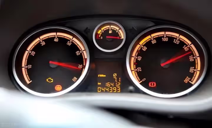 Traditional analog car instrument cluster with mechanical speedometer and tachometer