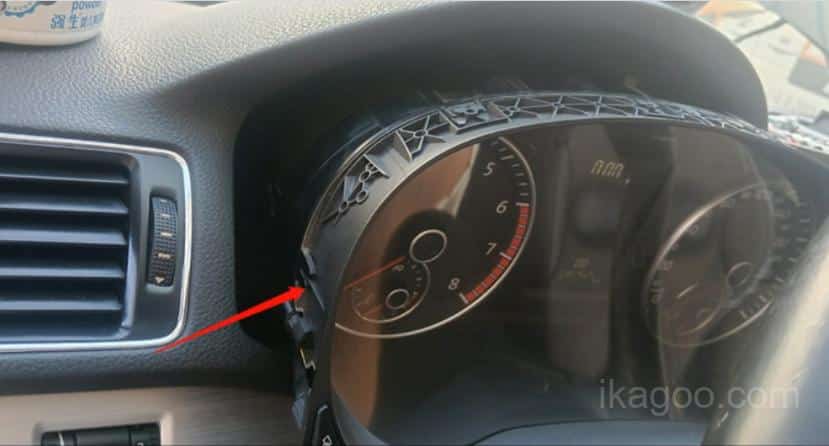 Prying out the original gauge assembly from a 2011-2015 Passat PQ dashboard