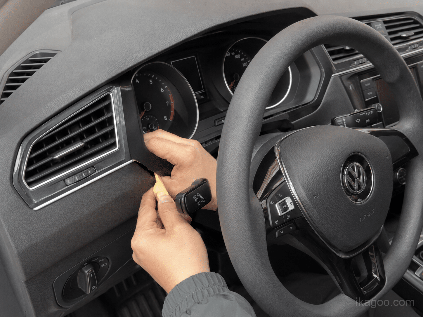 Prying open the dust cover below the instrument area for Volkswagen Tiguan 2017-2022 Full LCD Instrument Cluster installation