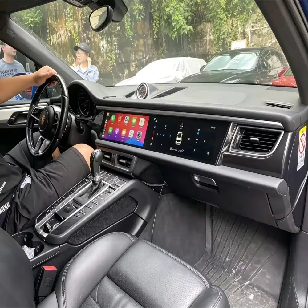 Porsche Macan 2014-2017 dual-screen system installed in a black interior, with original gauge cluster still in place
