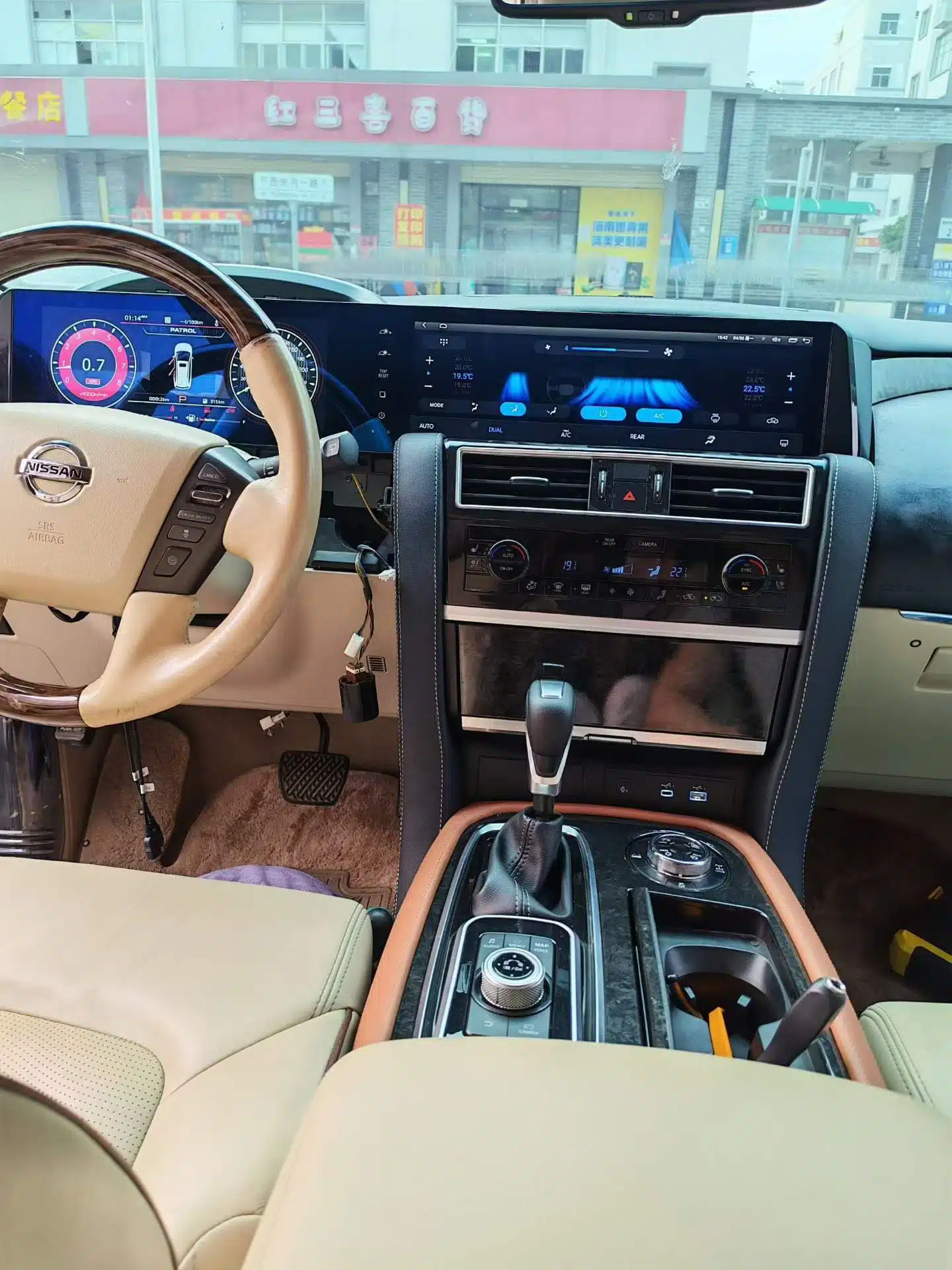 Nissan Patrol Y62 integrated dual screen displaying vehicle climate interface