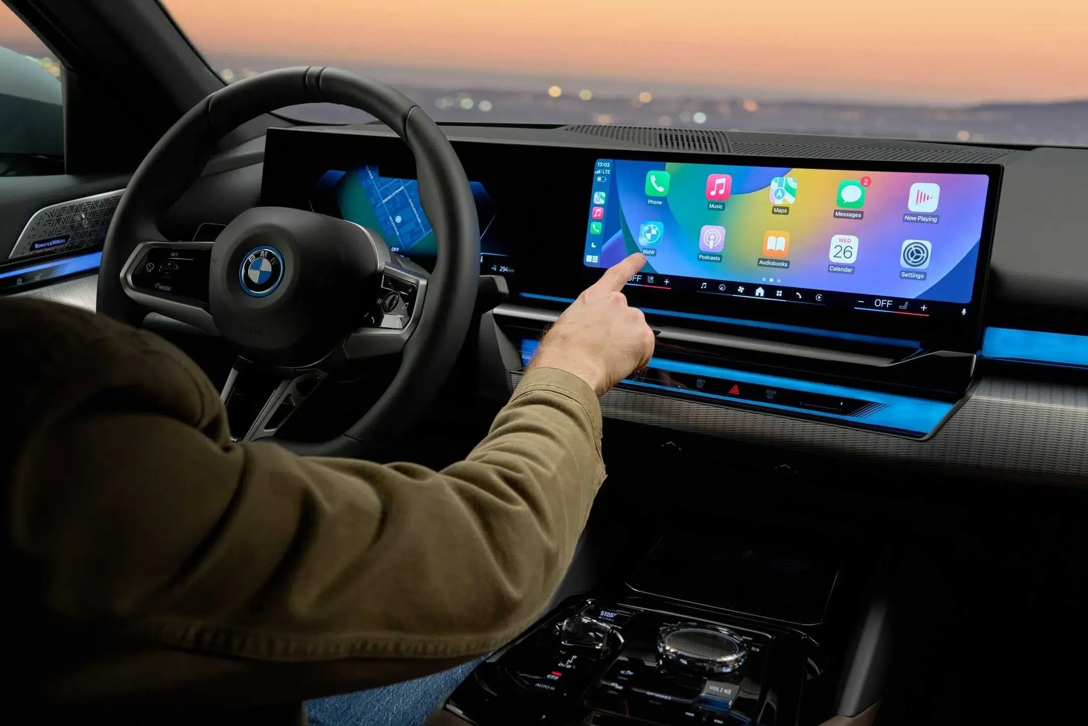 Installed BMW cockpit showing a wide upgraded display with app-based navigation, media and connected functions in real use