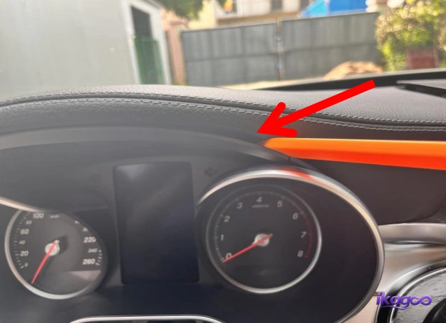 Upper edge of the original Mercedes instrument cluster being released from the dashboard