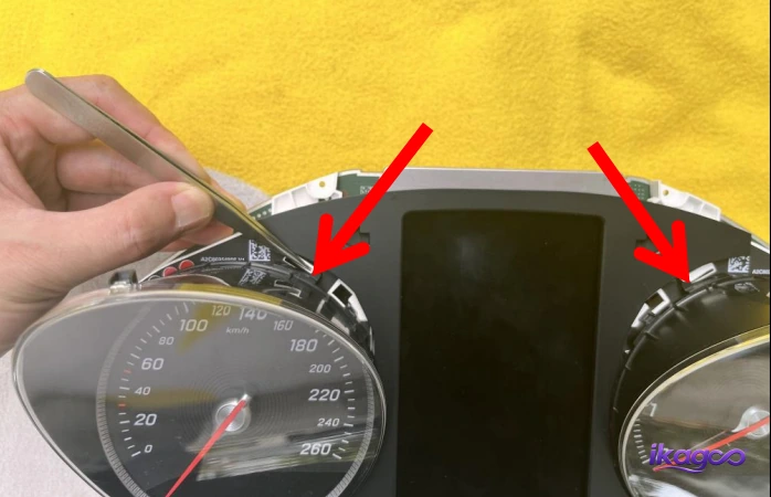 Retaining clips being released from the original Mercedes instrument cluster face
