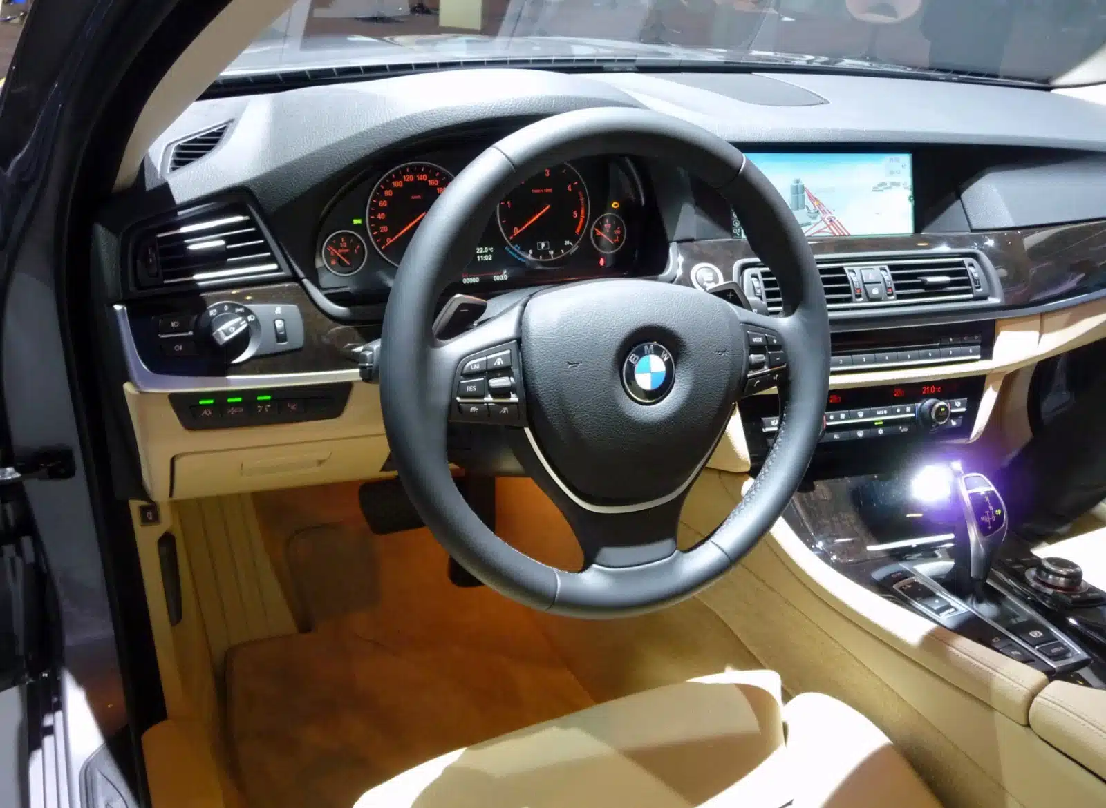 Original left-hand-drive BMW F10 instrument cluster and center dashboard before a modern digital display upgrade
