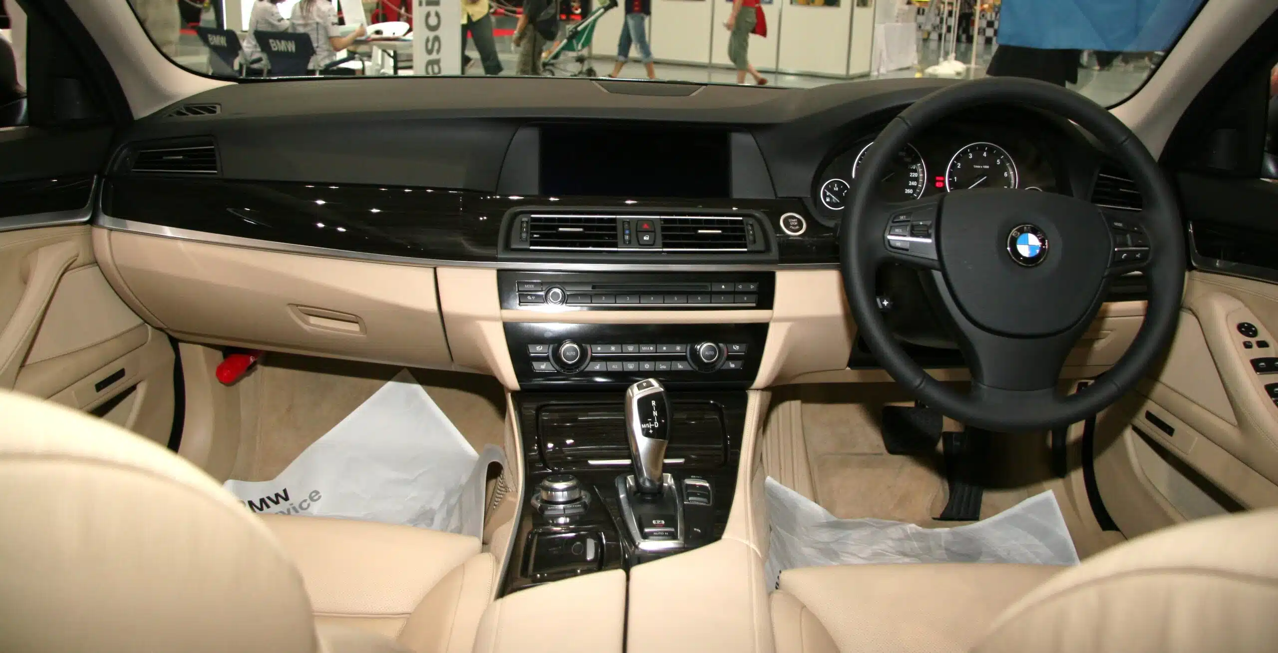 Original right-hand-drive BMW F10 cockpit used to explain steering-side and regional dashboard differences
